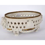 A Continental biscuit porcelain and gilt metal mounted oval basket, with pierced sides,