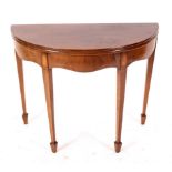 A George III mahogany half-round tea table, circa 1790,