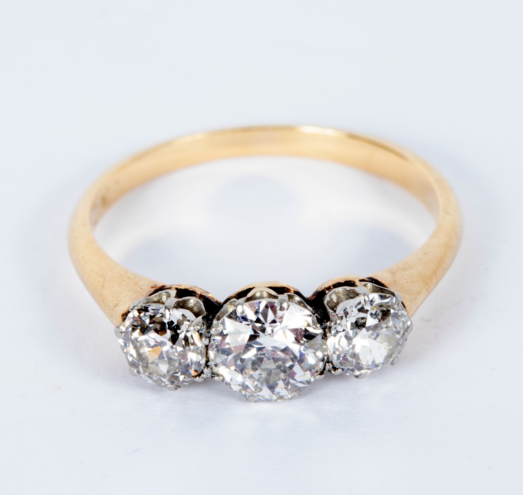 A diamond three-stone ring, the central stone of approximately 0.