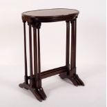 A nest of three oval tables on spindle turned supports and splay feet,