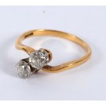 A diamond crossover ring, set in platinum and 18ct gold,
