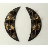 A pair of Oriental crescent shaped lacquer panels depicting figures in buildings etc,