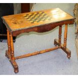 A Victorian walnut inlaid games table on twin turned columns,