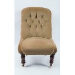 A Victorian deep buttoned back chair on turned front legs