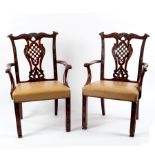 A pair of 19th Century mahogany Irish armchairs of Chinese Chippendale design with carved scrolling