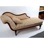 A Victorian upholstered scroll end settee with walnut show wood frame, on turned legs,