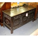 An 18th Century carved oak coffer with plain hinged cover,