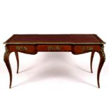 A Louis XVI style bureau plat with gilt metal mounts,