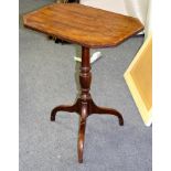 An early 19th Century mahogany table on a turned column and tripod support,