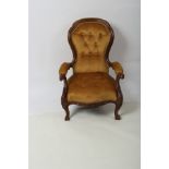 A Victorian walnut armchair, with moulded frame and carved eagle heads to the arm terminations,