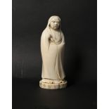 A Japanese carved ivory okimono of Daruma, Meiji period, wearing a robe and holding a fly whisk,