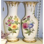 A pair of French porcelain baluster vases, painted bouquets of flowers,