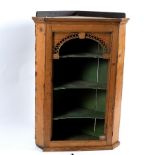 A mid 18th Century stripped pine hanging corner cupboard,