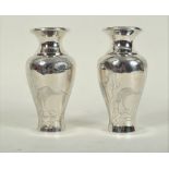 A pair of Japanese silver baluster vases, Meiji period, each decorated a crane beneath a pine tree,