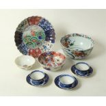 An Imari saucer dish with fluted rim, central decoration of waves and shells, 24cm diameter,