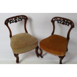 A pair of Victorian walnut nursing chairs, one with brass castors,