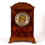 A walnut cased bracket clock, the silver chapter ring with Arabic numerals,