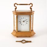 A gilt brass mantle clock set with porcelain panels of cherubs to the sides,