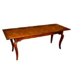 A cherry wood peg jointed table on square section cabriole legs,