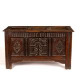 A Jacobean carved and panelled oak coffer,