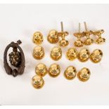Eight pairs of matching brass doorknobs and a brass door knocker with mask head centre