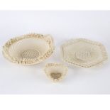 A Belleek circular two-handled basket, another heart-shaped example and a hexagonal dish,