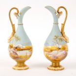 A pair of Royal Worcester small ewers, each painted with a stork at an oasis, matte blue sky,