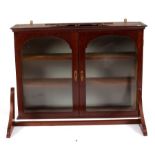 A small mahogany hanging cupboard,