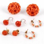 A pair of coral ear clips, carved as chrysanthemums and set in 14k gold,