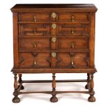 An oak chest of Jacobean design fitted four long drawers with raised panel fronts,