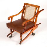 A late Victorian invalids chair with cane seat and back and carrying supports to the front and back,