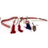 A Tibetan red leather horse strap with pierced silver coloured metal mounts,