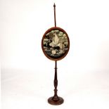 A late 19th Century pole screen with vase-shaped finial,