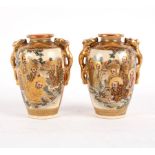 A pair of late 19th Century Japanese Satsuma two-handled oviform vases with gilt dragon handles,