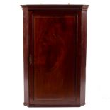An early 18th Century mahogany corner cupboard with Greek key cornice,