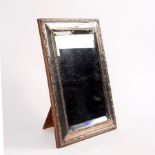 A silver framed mirror with easel back marks rubbed,