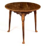 An oak cricket table raised on plain round legs with pad feet, 73.