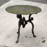 A pierced cast iron garden tabletop on an associated tripod support,