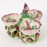 A Bow triple-shell sweetmeat dish, circa 1760, the puce painted shells with floral interior,