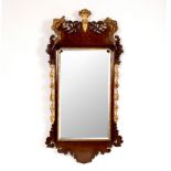 A late 18th Century style mahogany wall mirror with pierced and carved surround and applied gilt