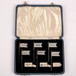 A set of silver sandwich flags, AS, Birmingham 1936, with interchangeable ivorine labels for Caviar,