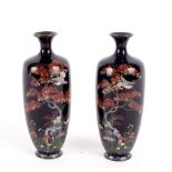 A pair of Japanese cloisonné baluster vases decorated birds in trees, flowers etc., 18.