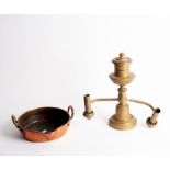 A copper preserving pan with single lip and a two-branch brass Pausa lamp
