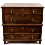 A Jacobean oak chest of four long drawers with drop handles,