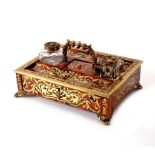 A 19th Century tortoiseshell and inlaid brass inkstand and pen tray with scroll decoration,