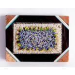 A micro mosaic paperweight, decorated with forget-me-nots and gilded opalescent corners,