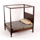 A doll's four poster bed, perhaps Heal's, with turned end posts, mattress and pillow, 54.