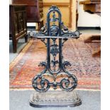 A cast iron umbrella stand, with foliate and mask decoration,