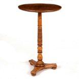 A 19th Century circular table on a ring turned elm column and flat tripod base,