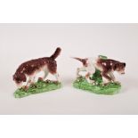 Two Derby style models of hunting dogs, one a pointer, 10cm x 18cm, the other a long haired hound,